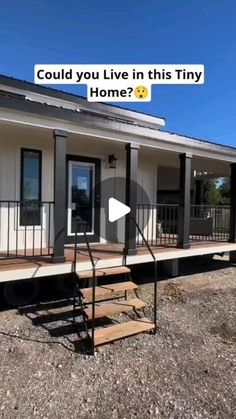 a tiny house with stairs leading up to the front door