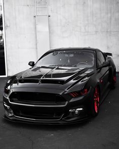 a black sports car parked in front of a building