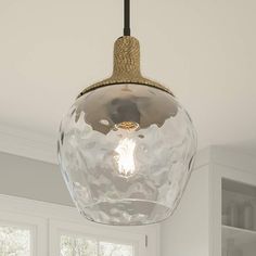 a light that is hanging from a ceiling in a room with white walls and windows