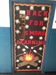 a door decorated to look like a campfire with the words back for s'more learning