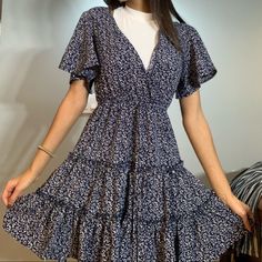 Navy Blue Dress W/ A Dainty White Floral Design - Must Have For Summer - Deep, V-Neck - Never Worn I’d Recommend For Us Sizes 2-4, On The Looser Side. Summer V-neck Dress With Ditsy Floral Print, Casual Blue Flowy V-neck Dress, Ditsy Floral Print Mini Dress V-neck For Vacation, Blue Flowy V-neck Casual Dress, Chic V-neck Mini Dress With Ditsy Floral Print, V-neck Ditsy Floral Print Dress For Brunch, Casual Floral Print V-neck Dress For Brunch, Casual V-neck Floral Print Dress For Brunch, Casual V-neck Dress With Ditsy Floral Print