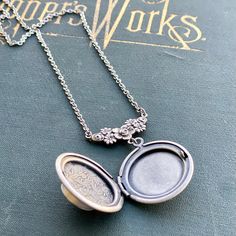 "Small working magnetic compass on an antiqued sterling silver plated locket made from a vintage design. On 26\" of silver plate chain but I can make this any other length by request. Just leave me a note at checkout. This compass is not waterproof." Nickel Free Antique Silver Necklace, Antique Silver Sterling Silver Vintage Locket Necklace, Silver Oval Brass Locket Necklace, Silver Oval Locket Necklace In Brass, Oval Silver Brass Locket Necklace, Oval Silver Locket Necklace In Brass, Antique Silver Medallion Locket Necklace With Vintage Charm, Antique Nickel-free Locket Necklace Collectible, Silver Vintage Charm Locket Necklace In Brass