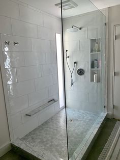 a walk in shower sitting inside of a bathroom