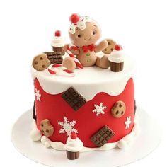 a red and white cake decorated with teddy bears, snowflakes and chocolates