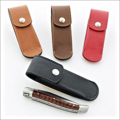 four different types of leather cases with one pen in the middle and two on each side