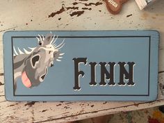 a sign that says finn with a horse's head on it