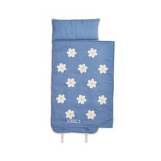 a blue sleeping bag with white flowers on the front and bottom, sitting against a white background