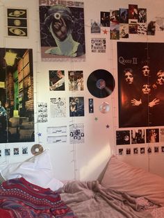 a bedroom with posters and pictures on the wall