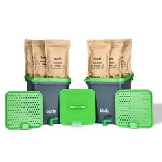 three bags of coffee sitting on top of each other next to a green container and grater