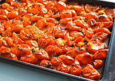 a pan filled with cooked tomatoes on top of a table