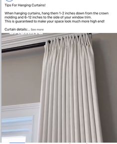 a white curtain hanging on the side of a window