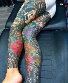 a woman with tattoos on her legs sitting in a chair