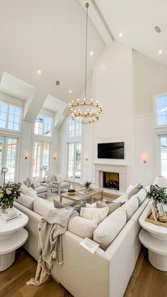 a living room filled with furniture and a fire place in the middle of a room