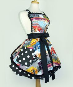 a mannequin wearing a dress made out of comic books and black polka dots