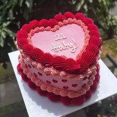 a heart shaped cake sitting on top of a table