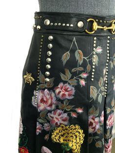 We the ity of this never Gucci Hand-Painted Leather Skirt Size M NEW crafted from supple black pleated leather with hand-painted flowers with hand-embroidered floral designs and studded detail. Featuring a gold-tone horsebit buckle on the waistband, a side zip closure and crepe silk lining.Condition: Pristine. This is a brand new item, never item. Black leather Size 42 (IT) Hand painted/embroidered flowers Stud detail Horsebit accent Side zip closure Fully lined Measurements, Waist 28'', Length 20.5” Luxury Spring Skirt, Gucci Skirt, Ysl Shoes, Jimmy Choo Sunglasses, Hand Painted Leather, Painting Leather, Hand Painted Flowers, Louis Vuitton Shoes, Dior Shoes