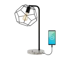 an electronic device is plugged into a lamp with a phone on the charger