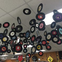 a room filled with lots of records hanging from the ceiling