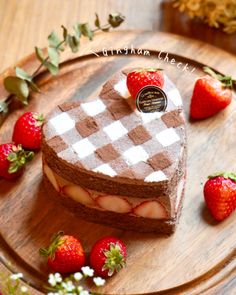 there is a heart shaped cake with strawberries on the plate