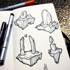 sketches of different shapes and sizes of objects on a notebook with a pen next to them