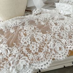 an image of white lace on the floor