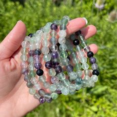 You will receive one intuitively chosen rainbow fluorite bead bracelet. Each piece varies slightly in color.  Fluorite is a sedimentary rock that can be many different colors such as green, purple, blue and yellow. It is associated with the heart, throat, and third eye chakras depending on its color. Fluorite helps with balancing energy and grounding, cleansing and purifying energy, increasing intuition, and strengthens connection to spirit. Check out the our full website for more art, stickers, crystals, jewelry and more! https://www.cosmicgeology.com/ Fluorite Gemstone Beads Bracelet For Healing, Fluorite Gemstone Beads Bracelets For Healing, Fluorite Gemstone Bracelets With Round Beads, Spiritual Fluorite Bracelets With Gemstone Beads, Spiritual Healing Fluorite Bracelet, Spiritual Fluorite Bracelet For Healing, Spiritual Fluorite Bracelets For Healing, Spiritual Fluorite Bracelets With Natural Stones, Fluorite Bracelet