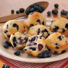 blueberry muffins on a plate with spoon