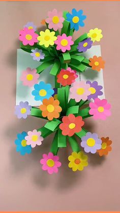 an origami flower bouquet made out of paper on a pink background with the words,