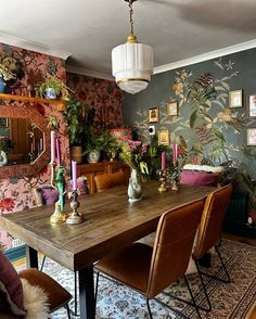 a dining room table surrounded by chairs and plants