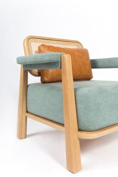 a wooden chair with blue upholstered cushions