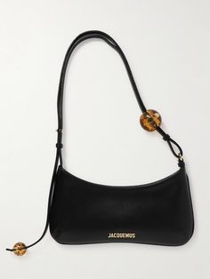 The curved shape of Jacquemus' 'Le Bisou Perle' bag is timelessly elegant. Crafted from smooth leather, it's embellished with resin spheres at each end of the sleek shoulder strap. The gold-tone hardware is polished for subtle shine. Jacquemus Bag, Iconic Bags, Black Shoulder Bag, Purse Accessories, Purses Designer, Cute Bags, Black Bag, Smooth Leather, Mini Bag