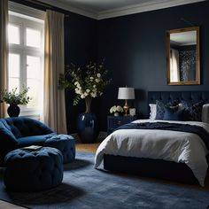 a bed room with a neatly made bed and a blue chair in front of a window