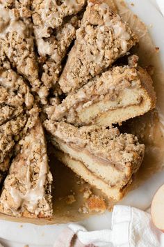 an apple crumb cake on a plate with slices cut out and ready to be eaten