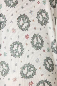 Get set for the holidays in a winter white long sleeve top and matching pants adorned with a vibrant green peace wreath pattern. Perfect for winter pajamas, this set captures the spirit of holiday jammies with its inviting Christmas wreath and peace holiday prints. Made from cozy peachy mini waffle fabric, it combines comfort and style, making it a delightful addition to your festive wardrobe. White Pj Set, Peace Wreath, Green Peace, Holiday Pjs, Capri Set, Waffle Fabric, Bamboo Pajamas, Winter Pajamas, Kickee Pants