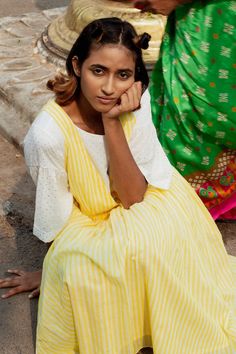 Yellow Mangalgiri handwoven dress with deep V neck and all over stripe pattern. Paired with white cotton mulmul top with polka dot foil print and flared sleeves.
Components: 2
Pattern: Handwoven and Printed
Type Of Work: Stripe Pattern and Foil Print
Neckline: Dress: Deep V Neck, Top: Boat Neck
Sleeve Type: Dress: Sleeveless, Top: Flared Sleeves
Fabric: Dress: Mangalgiri Handwoven, Top: Cotton Mulmul
Color: Yellow,White
Other Details: 
Pleated flare
Attached lining
Note: Only the yellow dress an Label Earthen, Dress Deep V Neck, Neckline Dress, Foil Print, Dress Sleeveless, Set For Women, Flared Sleeves, Yellow Dress, Aza Fashion