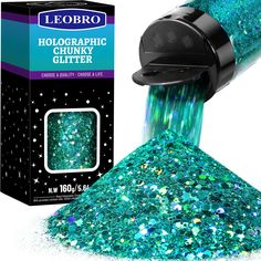 a blue and green glitter is being poured into a container