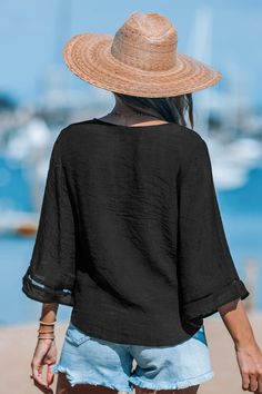 Introducing the Black Flared Sleeve and Tied-Waist Cover-Up. The flared sleeves and tied-waist detail add a touch of bohemian charm to this versatile piece. Whether thrown over your swimsuit or headed to a music festival, this top effortlessly combines comfort and style. Product code: CAA07A4A016AC Features:  Woven  V-neckline  Long flared sleeves Front buttons Waist tie Loose fit Wash Method: Regular Wash Material: 65%RAYON,35%POLYESTER. Vacation Tops With Tie Waist, Black Summer Tops With Tie Waist, Summer Beach Blouse With Tie Waist, Solid Summer Top With Tie Waist, Summer Solid Top With Tie Waist, Solid Color Summer Top With Tie Waist, Chic Vacation Blouse With Tie Waist, Summer Solid Color Tops With Tie Waist, Bohemian Beach Top