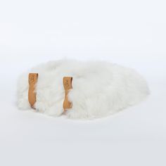 These Pearl white beauties are so precious they will be the most valuable item in your jewelry box. We mean your shoe collection. ETHICAL ALPACA FUR• Suri Description Slip with ease into the world's softest slippers. Baboosha Alpaca fur slippers deliver the perfect blend of style, elegance, and glamour of high fashion. Our luxury slippers are made for comfort both inside and outside the home. We use a thick vegetan leather sole and the finest Alpaca fur in the world, sourced ethically and cruelt Alpaca Slippers, Luxury Slippers, Suri Alpaca, Soft Slippers, Fashion Slippers, Designer Slippers, Fur Slippers, Material Design, Vegetable Tanned Leather