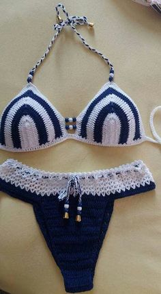 two pieces of crocheted swimwear on a bed