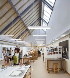 an artist's studio with people working on their paintings