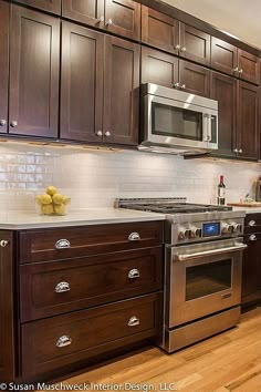 a kitchen with wooden cabinets and stainless steel appliances