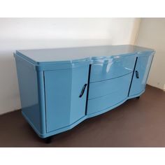 a blue sideboard with two doors and three drawers