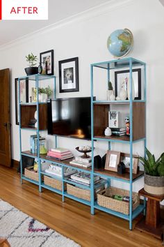 a living room filled with furniture and a flat screen tv on top of a wooden shelf