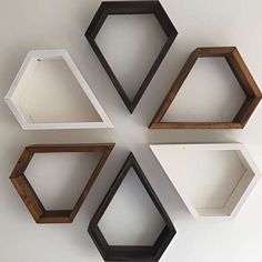 four hexagonal shelves sitting on top of each other in different shapes and sizes