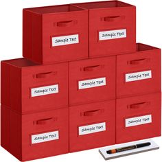 six red file boxes with labels on them and a pen next to one that says sample tax