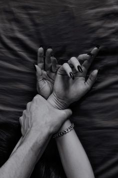 two hands reaching out to each other with their fingers extended in front of the camera