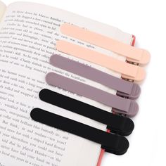 four bookmarks sitting on top of an open book