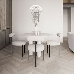 a white dining table with four chairs and a chandelier hanging from the ceiling