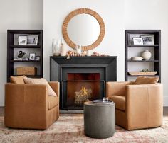 a living room filled with furniture and a fire place in front of a round mirror