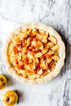 an apple pie sitting on top of a marble counter